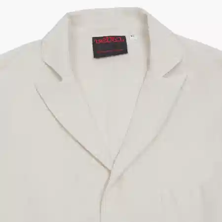 Peaked blazer in linen and cotton hopsack. Three button jacket; unstructured and unlined. 56% Cotton / 44% Linen. Made in France.